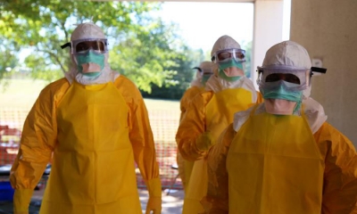 Medical aid workers in full protective gear